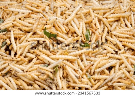 a photography of a pile of fried french fries with herbs, a close up of a pile of fried food with a lot of green leaves.