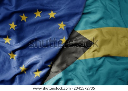 big waving realistic national colorful flag of european union and national flag of bahamas . macro