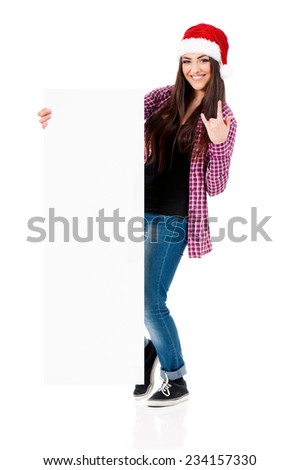Happy smiling girl in Santa Claus hat showing blank signboard, isolated on white background