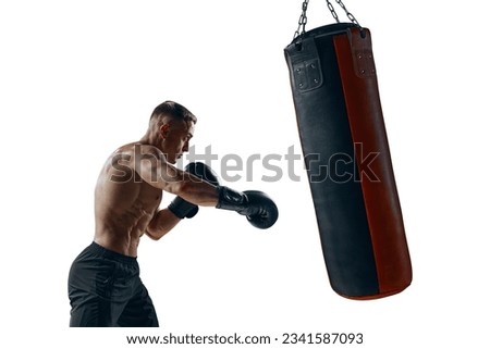 Silhouette of a strong male boxer punching boxing bag. Royalty-Free Stock Photo #2341587093