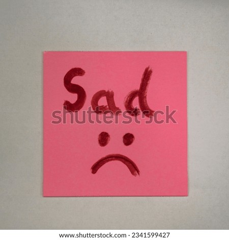a sad symbol in a pink sheet