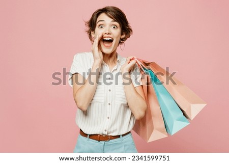 Young woman wear casual clothes hold shopping paper package bags scream sharing hot news about sales discount with hands near mouth isolated on plain pink background. Black Friday sale buy day concept Royalty-Free Stock Photo #2341599751
