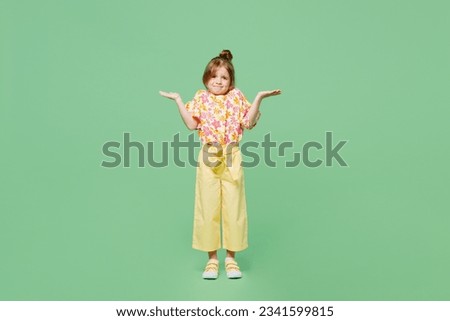 Full body sad little child kid girl 6-7 years old wear casual clothes shrugging shoulders looking puzzled isolated on plain pastel green background studio. Mother's Day love family lifestyle concept