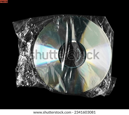 Cd compact disc inside a clear plastic bag isolated on black background