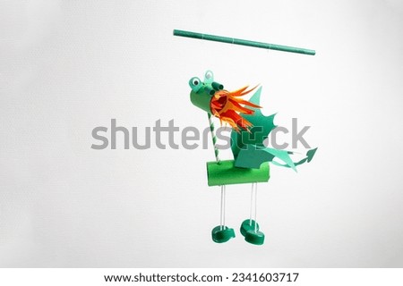 green fire breathing dragon marionette, recycled craft, DIY, easy Chinese New Year Crafts and ideas for kids