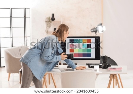 Female photographer working with computer in studio