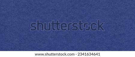 Texture of navy blue and ultramarine colors paper background, macro. Structure of dense craft cobalt cardboard. Felt backdrop closeup.