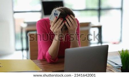 Worried woman having trouble shopping online using credit card and laptop Royalty-Free Stock Photo #2341642001