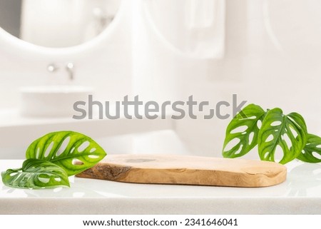 Wooden podium for bathing and spa products in defocused bathroom Royalty-Free Stock Photo #2341646041