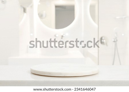 Empty marble podium in blurred bathroom to place your design Royalty-Free Stock Photo #2341646047