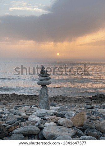 balanced stone men on the stone beach