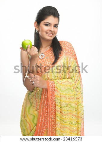 Teenage young indian girl with smiling face having green apple