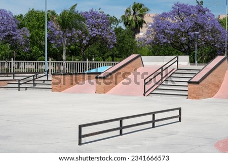 Brand new beautiful public skatepark during springtime  Royalty-Free Stock Photo #2341666573