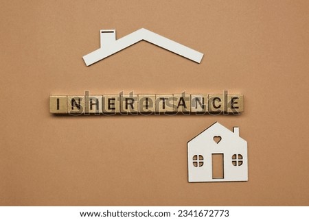 Word Inheritance made with wooden cubes and house model on brown background, flat lay Royalty-Free Stock Photo #2341672773