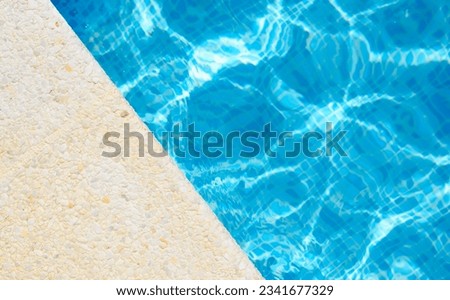 The edge of the pool on a sunny day at the hotel. Top view, copy space Royalty-Free Stock Photo #2341677329