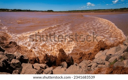 Fundy Discovery Site with Tidal Bore, the leading edge of the incoming tide from Cobequid Bay traveling up the Salmon River in Truro, Nova Scotia, Canada Royalty-Free Stock Photo #2341683539