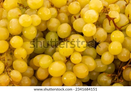 Background of ripe white grapes on a stall at a local market