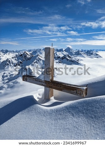 Summit cross on the Fluela Schwarzhorn above Davos. Ski mountaineering in Winter in the swiss alps. High quality photo. High quality photo
