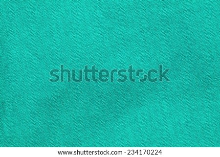 Close up photo of light green color filtered herringbone patterned fabric style represent the applied synthetic cloth production.  