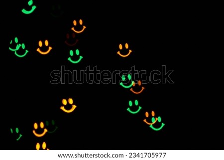 Garland with bokeh smiles shape flickering on the black background.