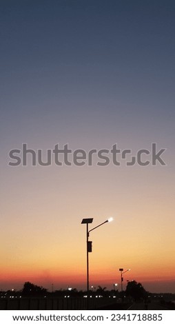 9:16 solar lights pole at sunset in public garden