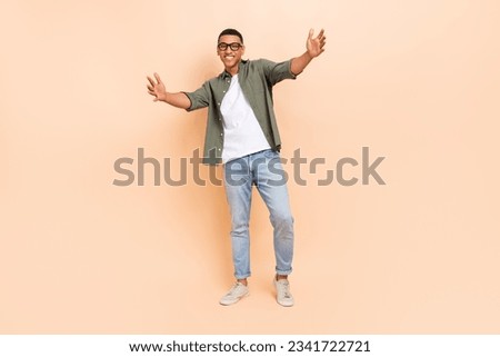 Full size portrait of cheerful satisfied person raise opened arms welcome invite you isolated on beige color background Royalty-Free Stock Photo #2341722721