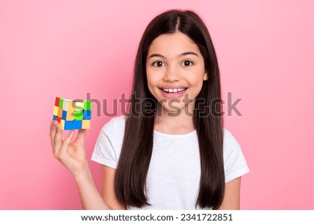 Photo portrait of cute schoolgirl solving task puzzle play game rubik cube wear trendy white outfit isolated on pink color background Royalty-Free Stock Photo #2341722851