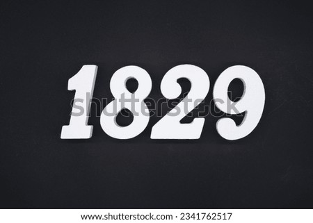 Black for the background. The number 1829 is made of white painted wood.