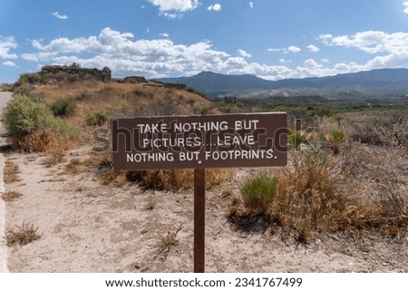 Take nothing but pictures... leave nothing but footprints. Sign at Tuzigoot National Monument reminds visitors of Leave No Trace ideology.  Royalty-Free Stock Photo #2341767499