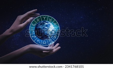 Woman holding illustration of Earth with zodiac wheel around it in open space, closeup