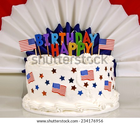 American Patriotic Themed Birthday Cake With Happy Birthday And Banner In Background Focus On Foreground