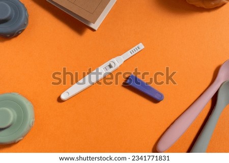 Positive Pregnancy Test. pregnancy test with two stripes. Positive result. Closeup. pregnancy test kit. motherhood concept. baby toys. baby items background. parenthood concept. Pregnancy Test result. Royalty-Free Stock Photo #2341771831