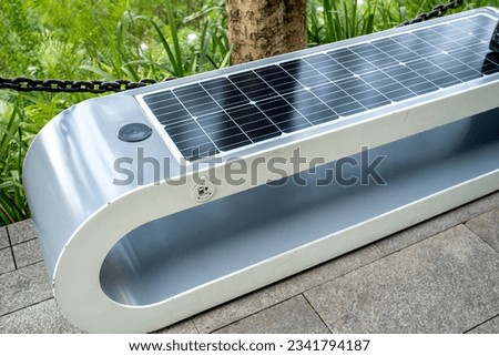 close up view of public bench in the park with solar panel installed. Royalty-Free Stock Photo #2341794187