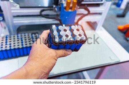 hand with Lithium ion industrial high current batteries and connector Royalty-Free Stock Photo #2341796119