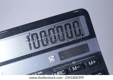 Calculator display showing the number of one hundred thousand from calculations. Mathematic, finance concept