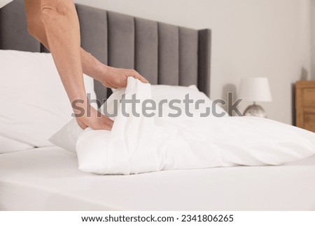 Woman changing pillowcase at home, closeup. Space for text Royalty-Free Stock Photo #2341806265