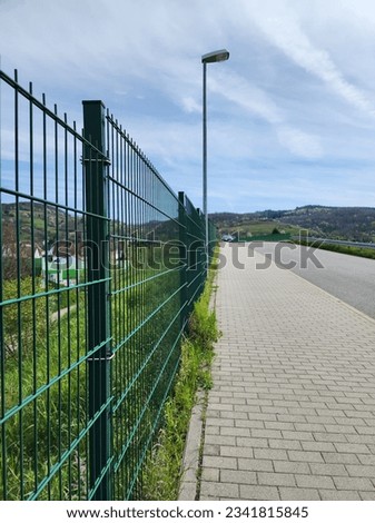 green wire mesh fence is commonly used to block the area The territory is simple, easy to set up and strong. Royalty-Free Stock Photo #2341815845