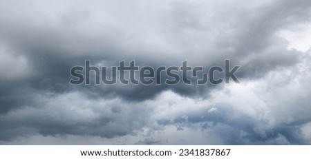 The image of the formidable storm clouds in close-up is sight that commands attention and evokes sense of awe and trepidation. Сlouds loom large, dominating frame with their dark and ominous presence.