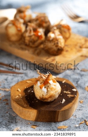 Takoyaki is a dish from the Kansai region of Japan.  small balls with a diameter of 3–5 cm