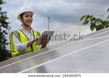 Asia woman engineer  on Solar panel clean energy. woman engineer checking solar cell  with solar panel.