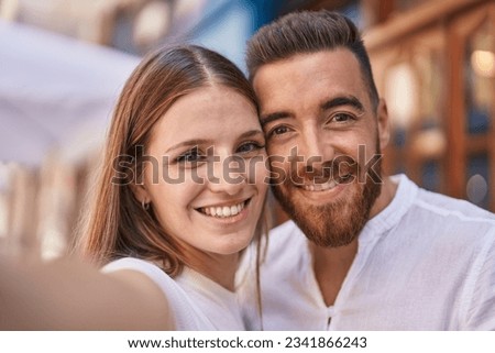 Man and woman couple smiling confident make selfie by camera at street