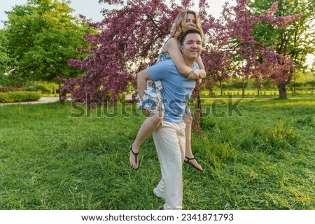 This pic captures a young couple goofin' around in the park. It's all about that joy, good times, fun evening, great relationship, and carefree vibes
