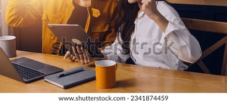 Cropped photo of Freelancer business Asian woman holding coffee cup and at doing planning analyzing the financial report, business plan investment, finance analysis the workplace. Royalty-Free Stock Photo #2341874459
