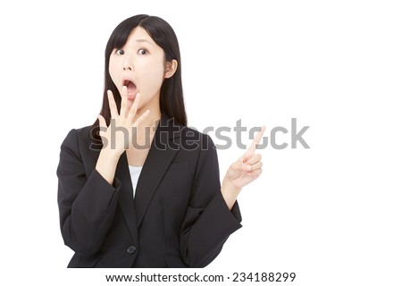 surprised Japanese businesswoman pointing side