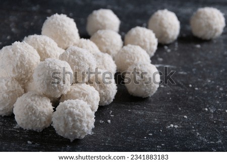 photo of coconut-flavored candy balls lying on a dark background close-up