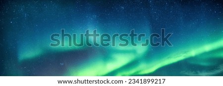 Fantastic Aurora borealis or northern lights with starry glowing in the night sky on Arctic circle at Norway Royalty-Free Stock Photo #2341899217