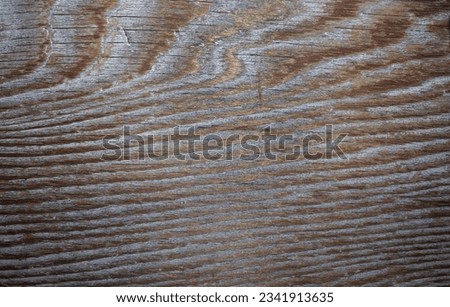 An aged wooden board with pronounced wood grain