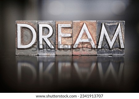 The word DREAM written in vintage letterpress type