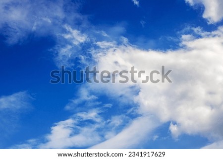 White clouds in bright blue sky close up