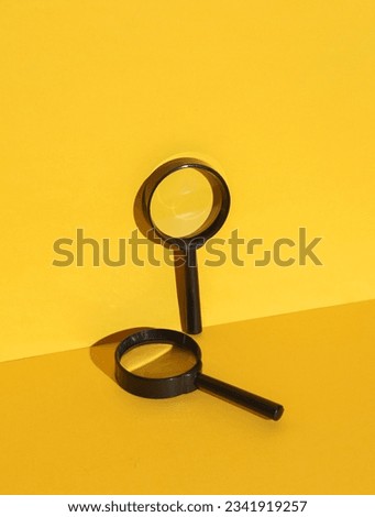 Magnifying glasses on yellow background with shadow. Creative layout. Minimal business concept. Conceptual still life